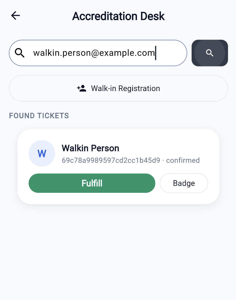Accreditation Desk — look up by email, booking id or code; Fulfill rotates the QR for hand-over, Badge shows the badge payload; Walk-in Registration issues a ticket on the spot.